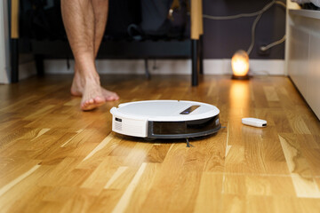 Housework and technology concept. Maintenance and service of robot vacuum cleaner. Cleaning,...