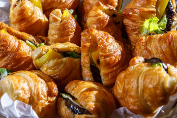 Croissants stuffed with lettuce leaves and fried vegetables. The concept of healthy eating.