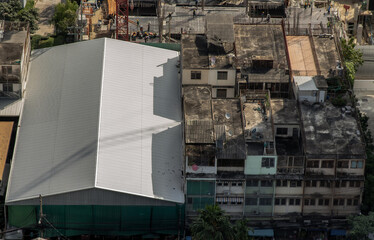 View from above on the white galvanized roof of the fresh market and old buildings deck at city. No...