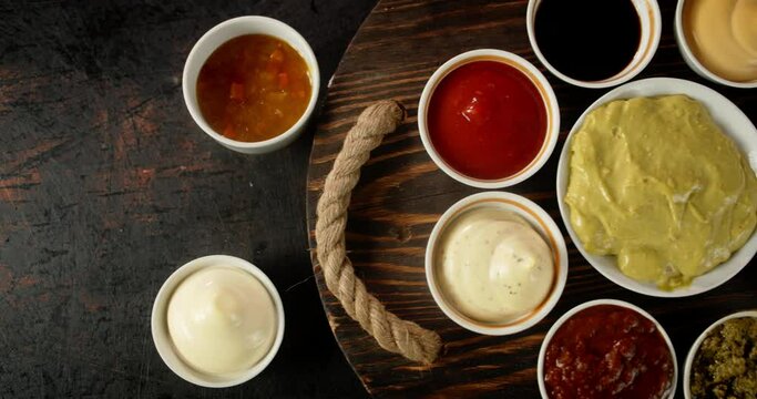 Different sauces in plates on the table.
