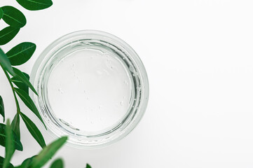 Transparent gel with bubbles texture in a transparent jar top view. Organic bio cosmetics,...