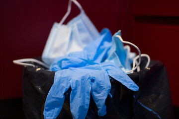 Medical masks are thrown in the trash.