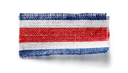 Costa Rica flag on a piece of cloth on a white background