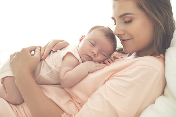 Obraz na płótnie Canvas Portrait of a beautiful mother, with her nursing baby. High quality photo.