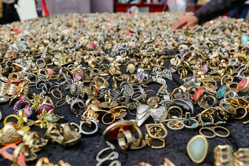 A selection of rings, pendants and jewelry on a table covered in black fabric