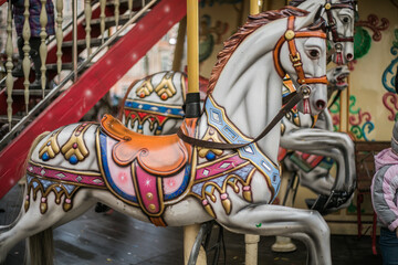 Fototapeta na wymiar Colorful carousel horse on a vintage illuminated roundabout carousel