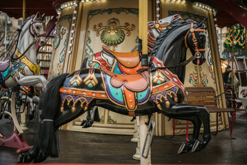 Colorful carousel horse on a vintage illuminated roundabout carousel