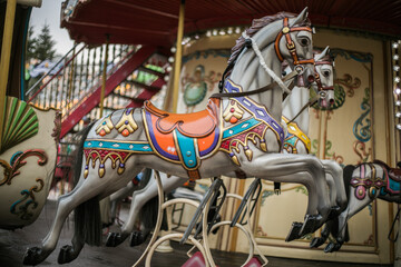 Colorful carousel horse on a vintage illuminated roundabout carousel