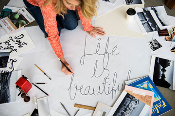 A female artist working on hand lettering project
