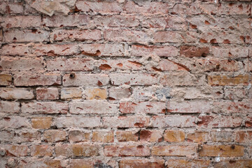 Brick texture from old stone. 18th century brick wall. Old burnt brick masonry. Shooting details close-up. Aged red clay color. Rectangular blocks laid out in rows and held together with cement.