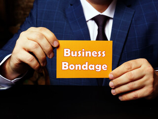 Businessman holding a blank business card. Business concept about Business Bondage with phrase on the sheet.