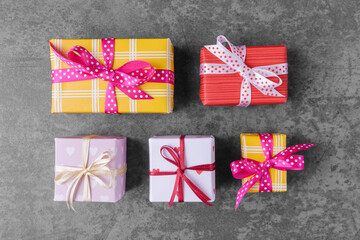Various gift boxes on grey stone background. Valentines day greeting
