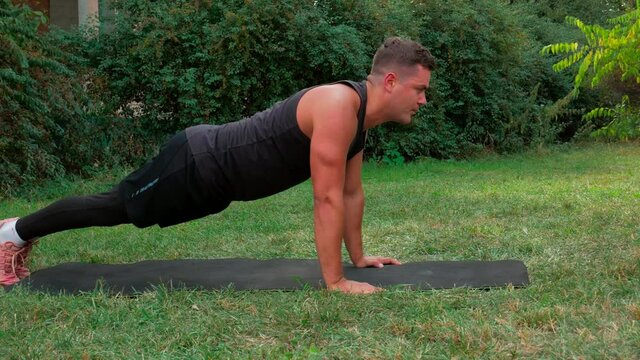 Man pushup exercise outdoor. Fit body push up workout in park. Guy sport lifestyle. Healthy strong athlete fitness training. Strong man pushups exercise. Muscular person workout training outside