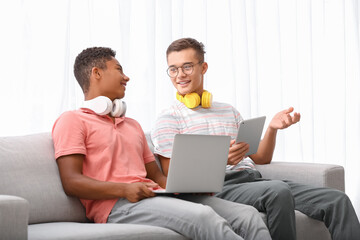 Teenage boys with different devices at home