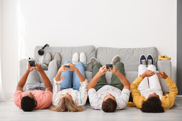Teenagers with mobile phones at home