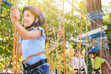 Obraz na płótnie Canvas Little girl climbing in adventure park