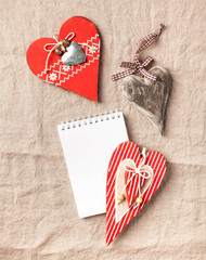 Blank Notepad for your text surrounded by a heart on a linen tablecloth. Valentine's Day card. Copy space.