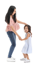 Pregnant Asian woman with her daughter on white background