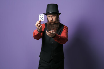 Male magician with cards on color background
