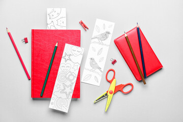 Cute bookmarks with stationery on light background