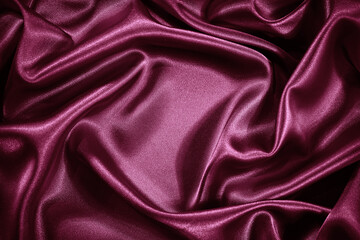 Red purple silk satin background. Shiny fabric with wavy soft pleats. Beautiful fabric background...