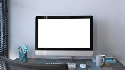 Front view of stylish workspace with computer, coffee cup, notebook and stationery. Blank screen for graphic display montage.