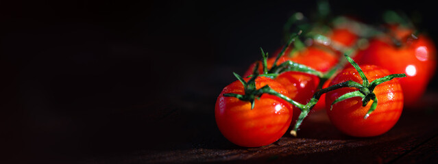 bright red cherry tomatoes on a dark background