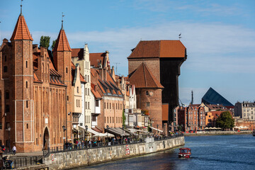 The largest medieval port Crane in Europe and historic buildings on the Dlugie Pobrzeze over the Motlawa River in Gdansk, Poland.