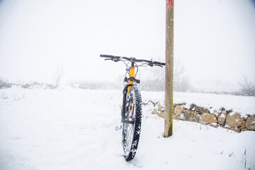 orange mountain bike in snowy landscape