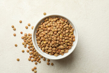 Bowl with legumes on white textured background