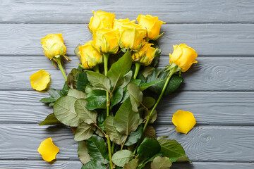 Beautiful yellow roses on wooden background