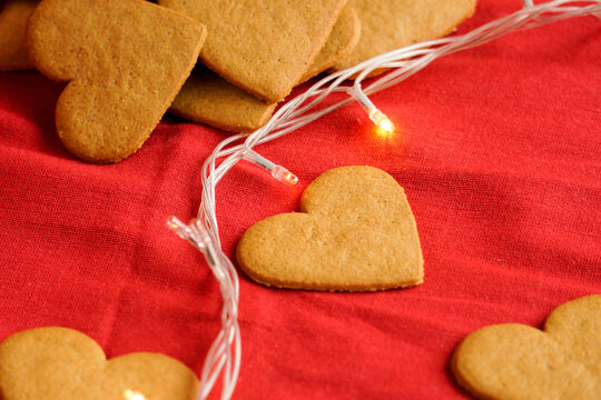 Valentine's day cookies background isolated on red with decorative lights. Valentine's day and love concept. Selective focus