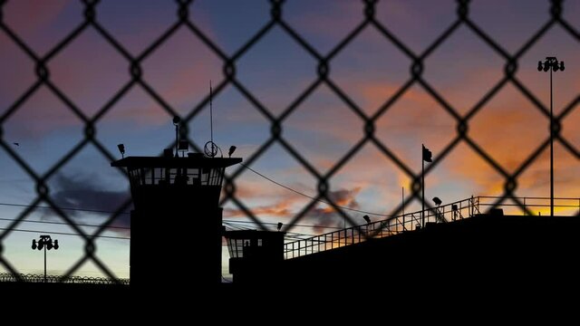 Prison at Sunrise with Guard Towers and Fence - Shallow DOF - 3D Illustration Animation