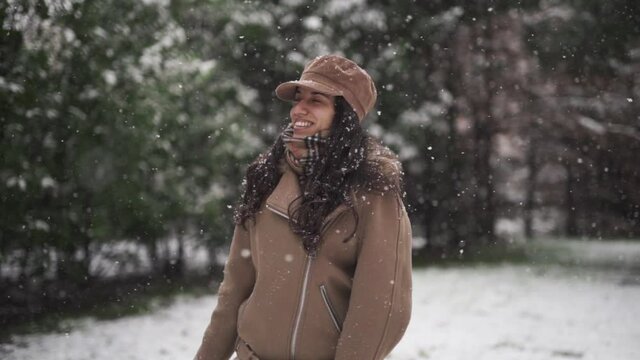 Mixed race woman enjoying in the snow during Filomena storm in Madrid