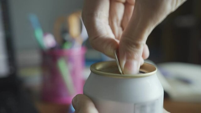 opening a beer can on working table