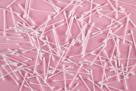 Cotton ear sticks, pink background.