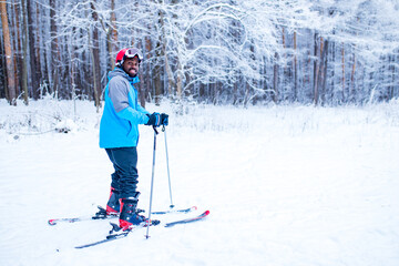 latin american young skier man forest winter day in New Year holidays Christmas