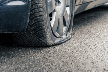 flat car tire close up, punctured wheel - obrazy, fototapety, plakaty