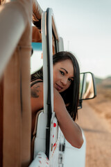 Latin woman portrait looking outside car window