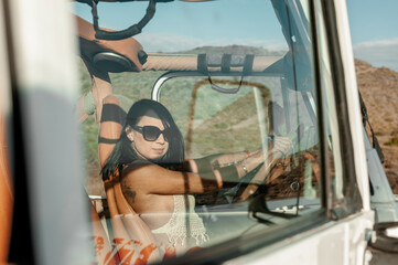 Latin woman sitting in 4x4 vehicle