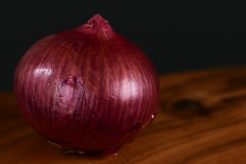 Red onion on wooden board.