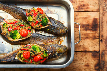 Baked fish stuffed with vegetables