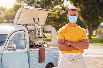 Portrait Of Man Wearing Face Mask Running Independent Mobile Coffee Shop Standing Next To Van