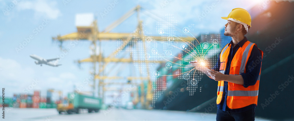 Leinwandbilder engineer. foreman using tablet and control loading container from cargo freight ship to truck and ic
