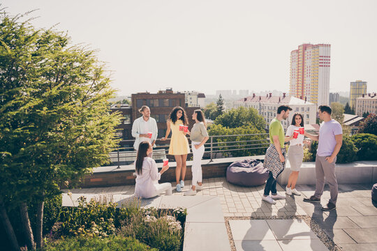 Full body photo of young friends gathered together have fun enjoy chill rooftop party drink chat communicate