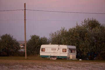 residential van near the bushes in the light of the setting sun