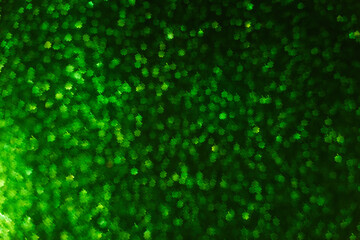 Blurred defocused bokeh background. Texture of green black shamrocks quatrefoil for good luck. Template for St. Patrick's holiday greeting cards. Abstraction template. Copy space Layout for decoration
