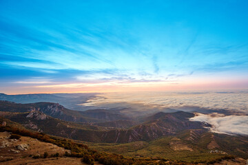 sunrise on the coast in clouds and mountains