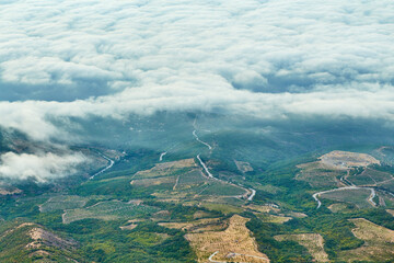 bird's eye view of the village with hills and clouds