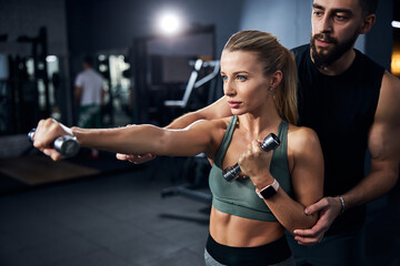 Trainer helping a female with her punch coordination